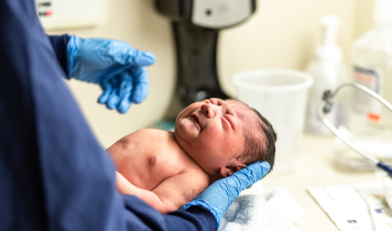 Newborn baby receiving gentle care and health monitoring by a pediatric specialist at Balaji's Hospital Dr. Gowri's Hospital in Tirupati, providing expert newborn healthcare for first-time parents.