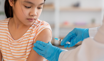 Pediatric doctor administering a vaccination to a child at Balaji's Hospital Dr. Gowri's Hospital in Tirupati, ensuring safe immunization and preventive healthcare for children.