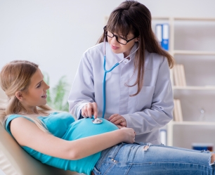 Doctors monitoring a pregnant woman and her baby's health during maternity care at Doctor Gowri's Balaji Hospital, Tirupati.