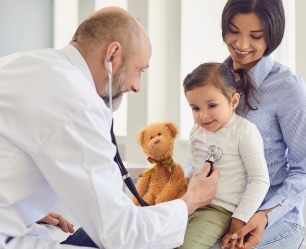 Doctor examining a child with a stethoscope during a pediatric checkup at Doctor Gowri's Balaji Hospital, Tirupati.